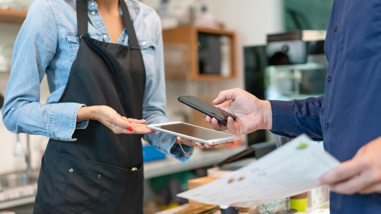 A small business worker making a transaction with a customer