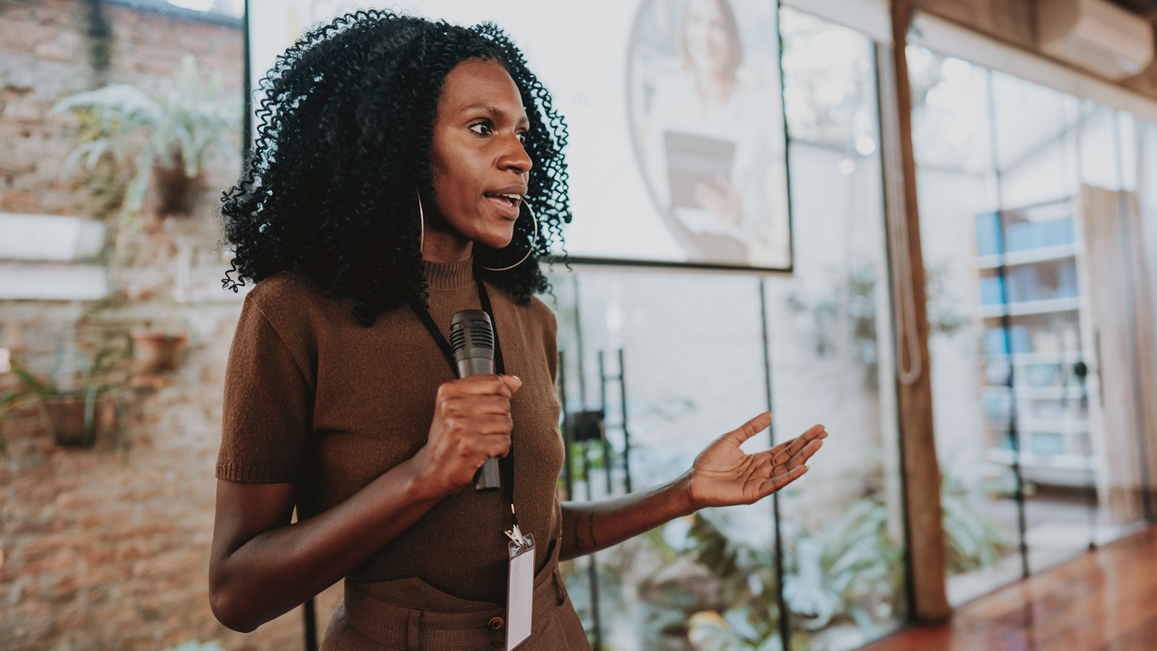 image of a woman speaking at an event