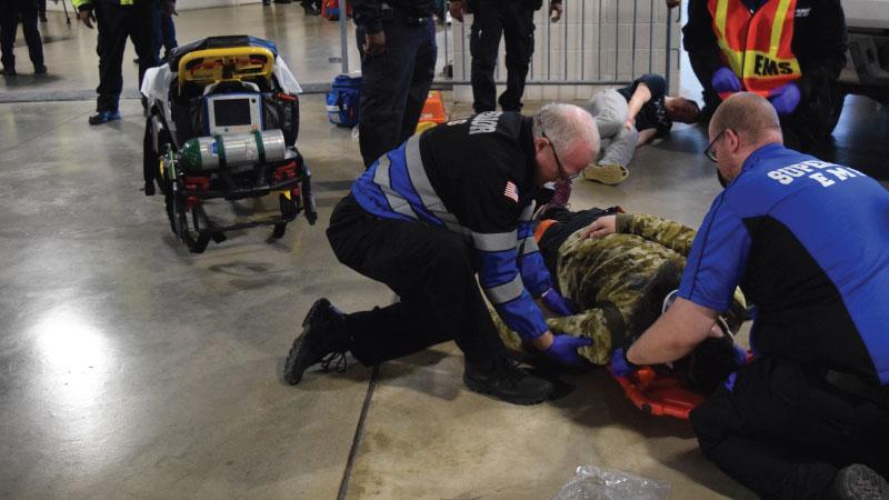 Photo of emergency responders assisting person during an exercise