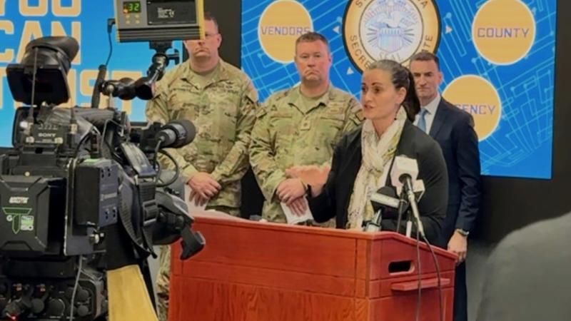 Caitlin Conley speaking at a podium