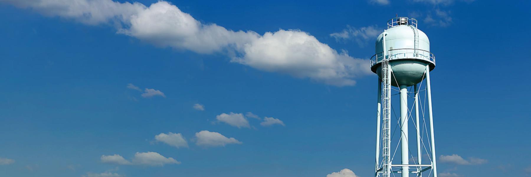 Water tower against a blue cloudy sky