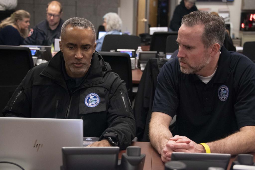 (l-r) CISA Region 9 Protective Security Advisor Brian Keith and Cybersecurity Advisor Jake Aguiar monitor critical infrastructure from the Multi-Agency Command Center in Las Vegas during Super Bowl LVIII Week. 